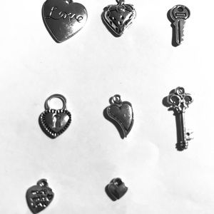 Eight silver plated charms.
